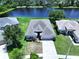 Aerial view of a well-maintained home with a two-car garage, a pristine yard and views of the adjacent lake at 6314 Gondola Dr, Riverview, FL 33578