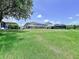 Expansive backyard featuring lush green grass, a fence, and space for outdoor activities at 6314 Gondola Dr, Riverview, FL 33578