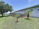 Landscaped backyard area with a small wooden fence and palm trees at 6314 Gondola Dr, Riverview, FL 33578