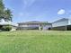 Exterior backyard featuring a lawn and partial wooden fence on a sunny day at 6314 Gondola Dr, Riverview, FL 33578
