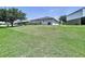 Spacious backyard area with a large grassy lawn, and surrounding homes at 6314 Gondola Dr, Riverview, FL 33578