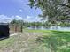Picturesque backyard with a serene lake view, wooden fence, and lush greenery, perfect for relaxation at 6314 Gondola Dr, Riverview, FL 33578