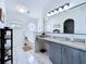 Bright bathroom featuring large vanity, updated fixtures, and soaker tub under window at 6314 Gondola Dr, Riverview, FL 33578