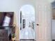 Arched doorway leading into bathroom with double vanity, tiled floor, and soaker tub at 6314 Gondola Dr, Riverview, FL 33578