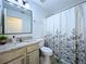 Bathroom featuring a floral shower curtain and granite-look vanity countertop at 6314 Gondola Dr, Riverview, FL 33578