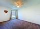 Spacious carpeted bedroom with a ceiling fan and a window offering natural light at 6314 Gondola Dr, Riverview, FL 33578