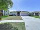 Inviting one-story home with a spacious driveway, attached garage, and manicured front yard at 6314 Gondola Dr, Riverview, FL 33578