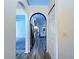Bright hallway featuring arched doorways and wood-look flooring at 6314 Gondola Dr, Riverview, FL 33578