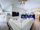 Comfortable living area showcases a white sectional, blue accent wall, and stylish furnishings at 6314 Gondola Dr, Riverview, FL 33578