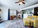 Bright living room with modern furnishings, area rug, and view to the kitchen at 6314 Gondola Dr, Riverview, FL 33578