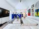 Well-lit living room with stylish white sectional, blue accent wall, and modern decor at 6314 Gondola Dr, Riverview, FL 33578