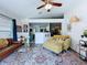 Bright living room with modern furnishings, area rug, and open view to the kitchen at 6314 Gondola Dr, Riverview, FL 33578