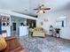 Cozy living room featuring a brown sofa, sliding glass doors to a deck, and view to the kitchen at 6314 Gondola Dr, Riverview, FL 33578