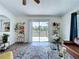 Bright living room with sliding glass doors leading to deck and fenced backyard at 6314 Gondola Dr, Riverview, FL 33578