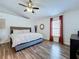 Comfortable main bedroom with vaulted ceiling, ceiling fan, and wood-look flooring at 6314 Gondola Dr, Riverview, FL 33578