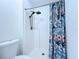 Bathroom shower has white tiling and a vibrant, patterned shower curtain at 6314 Gondola Dr, Riverview, FL 33578