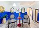 Charming sitting area featuring striped chairs, blue accent wall, and stylish decor at 6314 Gondola Dr, Riverview, FL 33578