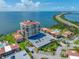 An elevated view showing the condo building, parking lot, and surrounding waterfront neighborhood with a bridge at 6372 Palma Del Mar S Blvd # 601, St Petersburg, FL 33715
