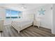 Bright bedroom features a large window with water views, ceiling fan, and stylish nautical decor at 6372 Palma Del Mar S Blvd # 601, St Petersburg, FL 33715