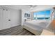 Bedroom features an ocean view and a large window, complemented by neutral décor and a ceiling fan at 6372 Palma Del Mar S Blvd # 601, St Petersburg, FL 33715