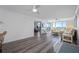 Bright and open living room with wood floors, ceiling fans and sliding glass doors with a beautiful ocean view at 6372 Palma Del Mar S Blvd # 601, St Petersburg, FL 33715