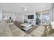 Spacious living room featuring plank flooring, a TV, and sliding glass doors to the balcony at 6372 Palma Del Mar S Blvd # 601, St Petersburg, FL 33715