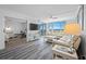 This bright living space features wood floors, a large sectional and sliding doors to a balcony with ocean views at 6372 Palma Del Mar S Blvd # 601, St Petersburg, FL 33715