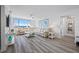 Bright living room with wood floors, beach-themed artwork and a large sectional with a view of the ocean at 6372 Palma Del Mar S Blvd # 601, St Petersburg, FL 33715