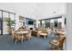 Large community lounge with couches, chairs, tables, and a library in a stylish common area at 6372 Palma Del Mar S Blvd # 601, St Petersburg, FL 33715