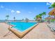 Inviting pool area surrounded by palm trees and lounge chairs, perfect for relaxation at 6372 Palma Del Mar S Blvd # 601, St Petersburg, FL 33715