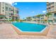 Beautiful pool and deck with plenty of lounge chairs, tiki umbrellas, and views of the surrounding property at 6372 Palma Del Mar S Blvd # 601, St Petersburg, FL 33715
