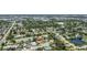Neighborhood aerial view shows mature trees, a small lake, and proximity to industrial park at 6921 8Th Street E Ct, Sarasota, FL 34243