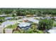 Beautiful aerial view of a cozy pool home with lush landscaping, mature trees, and a screened lanai at 6921 8Th Street E Ct, Sarasota, FL 34243