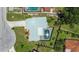 Aerial view of a property with a screened pool, updated roof, a driveway, and mature trees at 6921 8Th Street E Ct, Sarasota, FL 34243