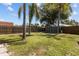 Spacious backyard featuring a storage shed, mature trees, and ample green space for outdoor activities at 6921 8Th Street E Ct, Sarasota, FL 34243