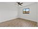 Empty bedroom with hardwood floors, white walls, and natural light from a window at 6921 8Th Street E Ct, Sarasota, FL 34243
