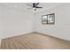 This bedroom features wood flooring, ceiling fan and a window that allows plenty of natural light at 6921 8Th Street E Ct, Sarasota, FL 34243
