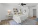 Stylishly decorated bedroom with a patterned rug, bedside tables with lamps, and wood flooring at 6921 8Th Street E Ct, Sarasota, FL 34243