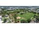 Aerial view of a neighborhood park with playground, picnic shelter, baseball field, and open green spaces at 6921 8Th Street E Ct, Sarasota, FL 34243
