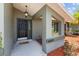 A welcoming front entrance featuring a stylish door, an inviting overhead light, and attractive landscaping at 6921 8Th Street E Ct, Sarasota, FL 34243
