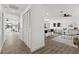 A bright, open hallway flows into the living area with a modern kitchen and sleek furnishings at 6921 8Th Street E Ct, Sarasota, FL 34243