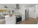 Open kitchen featuring modern appliances, a central island, and seamless flow into the living area at 6921 8Th Street E Ct, Sarasota, FL 34243