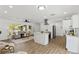 Open-concept space features a bright living room, modern kitchen, and sleek wood flooring at 6921 8Th Street E Ct, Sarasota, FL 34243