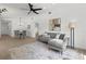 Bright, open-concept living area with a sectional sofa, dining table, and sleek wood flooring at 6921 8Th Street E Ct, Sarasota, FL 34243