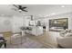 Open-concept living area with bright kitchen island, modern white cabinetry, and access to screened pool at 6921 8Th Street E Ct, Sarasota, FL 34243