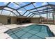 Enjoy a refreshing swim in the screened-in pool, surrounded by a spacious patio and lush landscaping at 6921 8Th Street E Ct, Sarasota, FL 34243