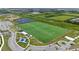 Aerial view of the Southshore Sportplex, showing sports fields, parking and playground, surrounded by green fields and neighborhood at 7420 Paradiso Dr, Apollo Beach, FL 33572