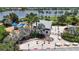 Aerial view of the community clubhouse with playground, outdoor seating and tables, with a lake in the background at 7420 Paradiso Dr, Apollo Beach, FL 33572