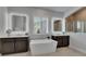 Bright bathroom featuring double vanity, soaking tub, and elegant lighting at 7420 Paradiso Dr, Apollo Beach, FL 33572