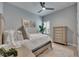 Comfortable bedroom featuring a ceiling fan, large window with plantation shutters, and a wood dresser at 7420 Paradiso Dr, Apollo Beach, FL 33572